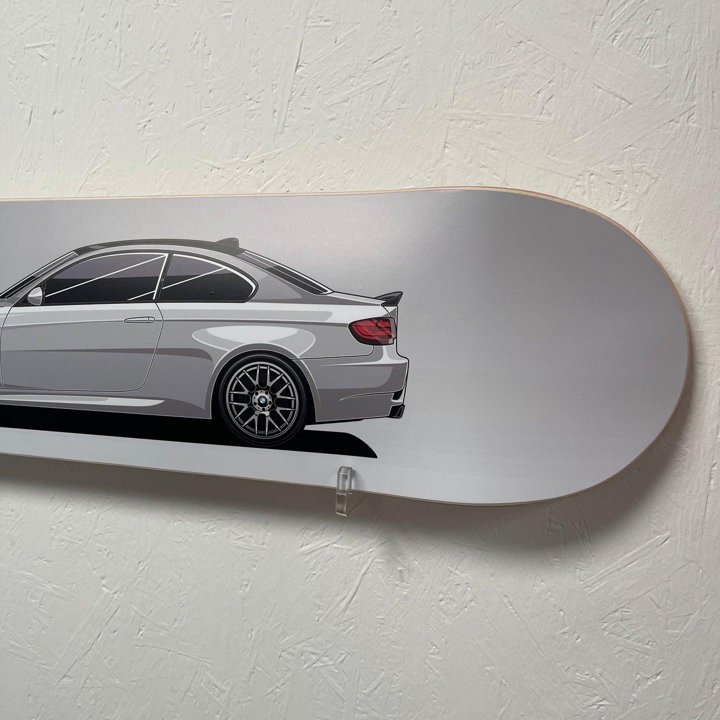 Skateboard with a car design on a light gray background