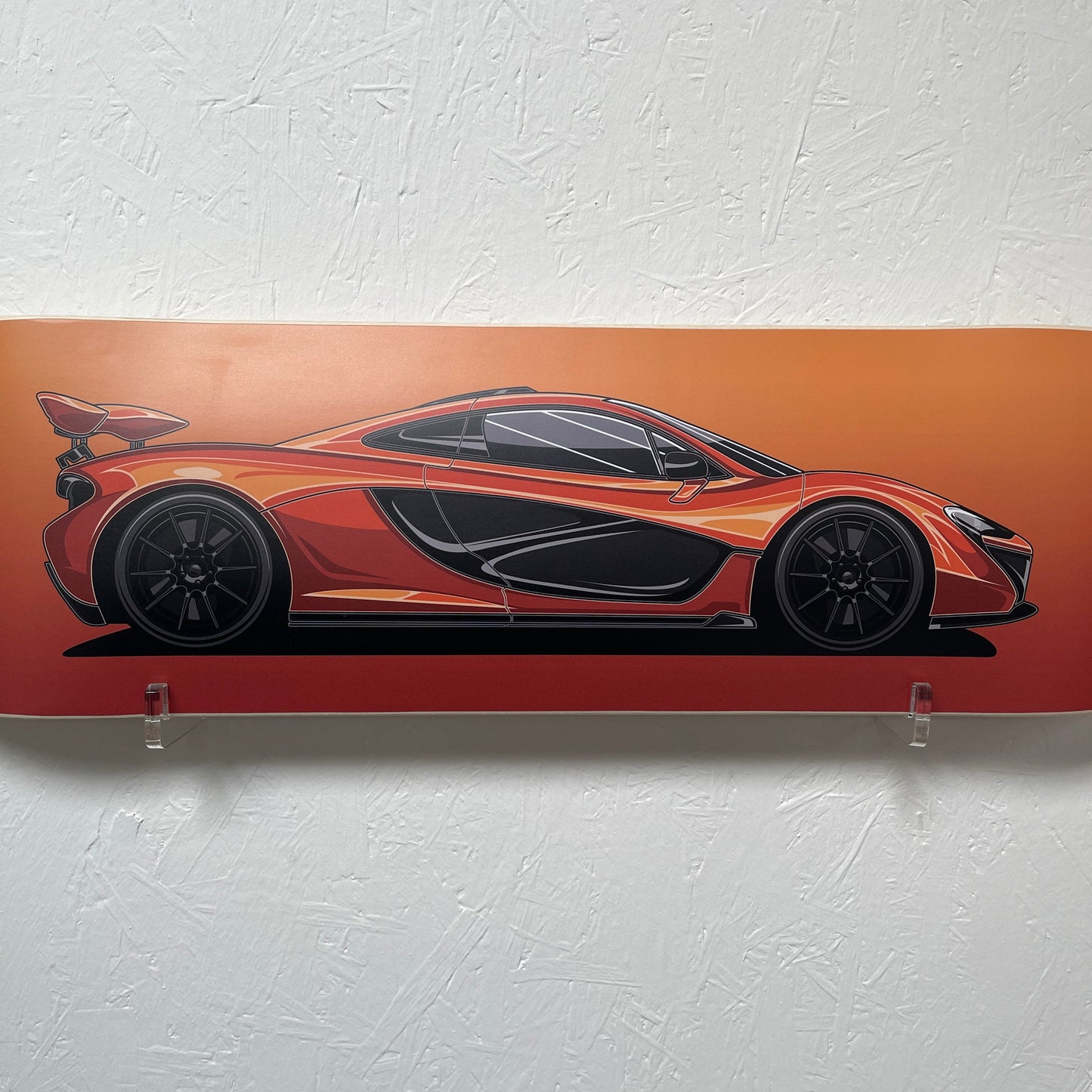 Decorative wall art of a stylized car on an orange background