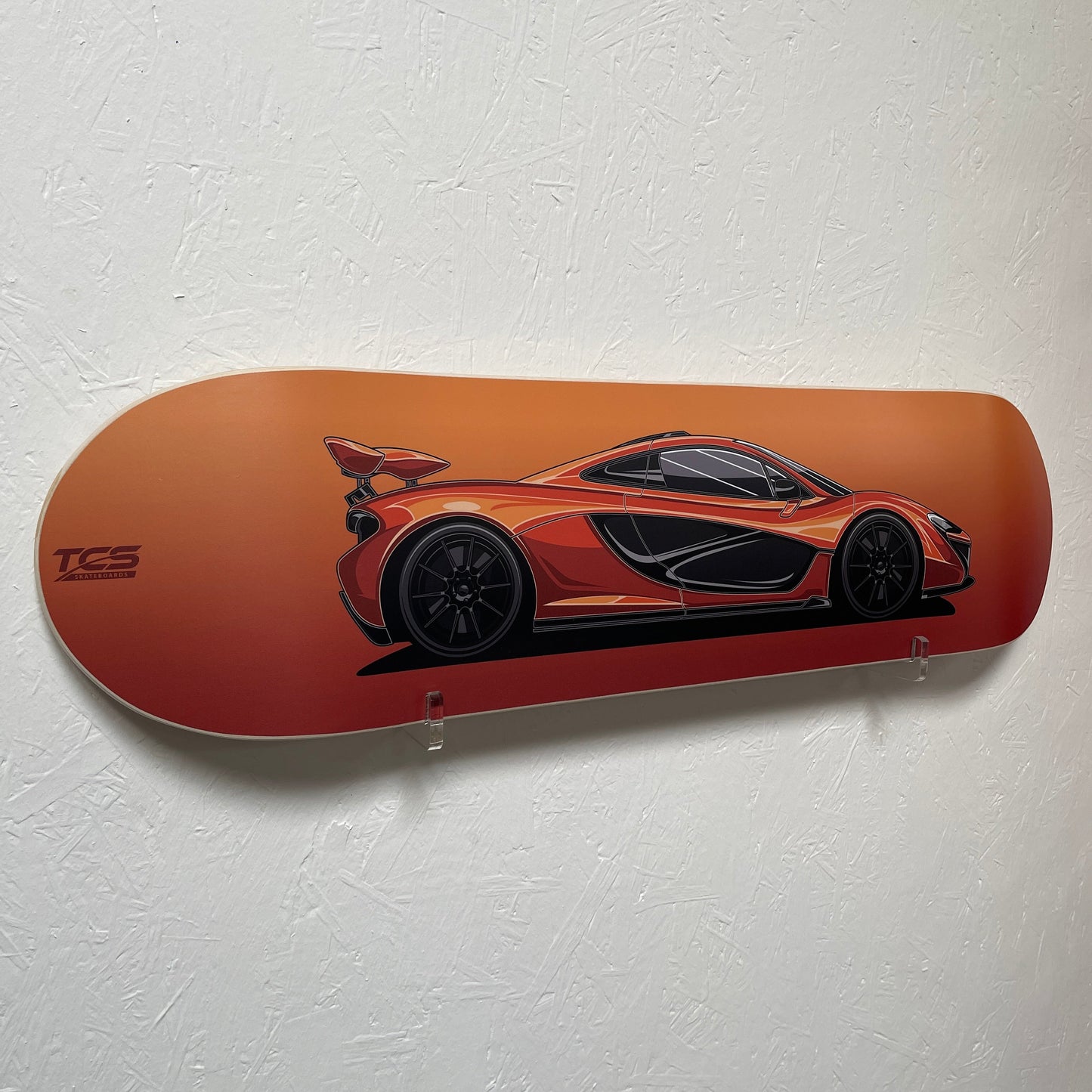 Skateboard deck with car design on a white background