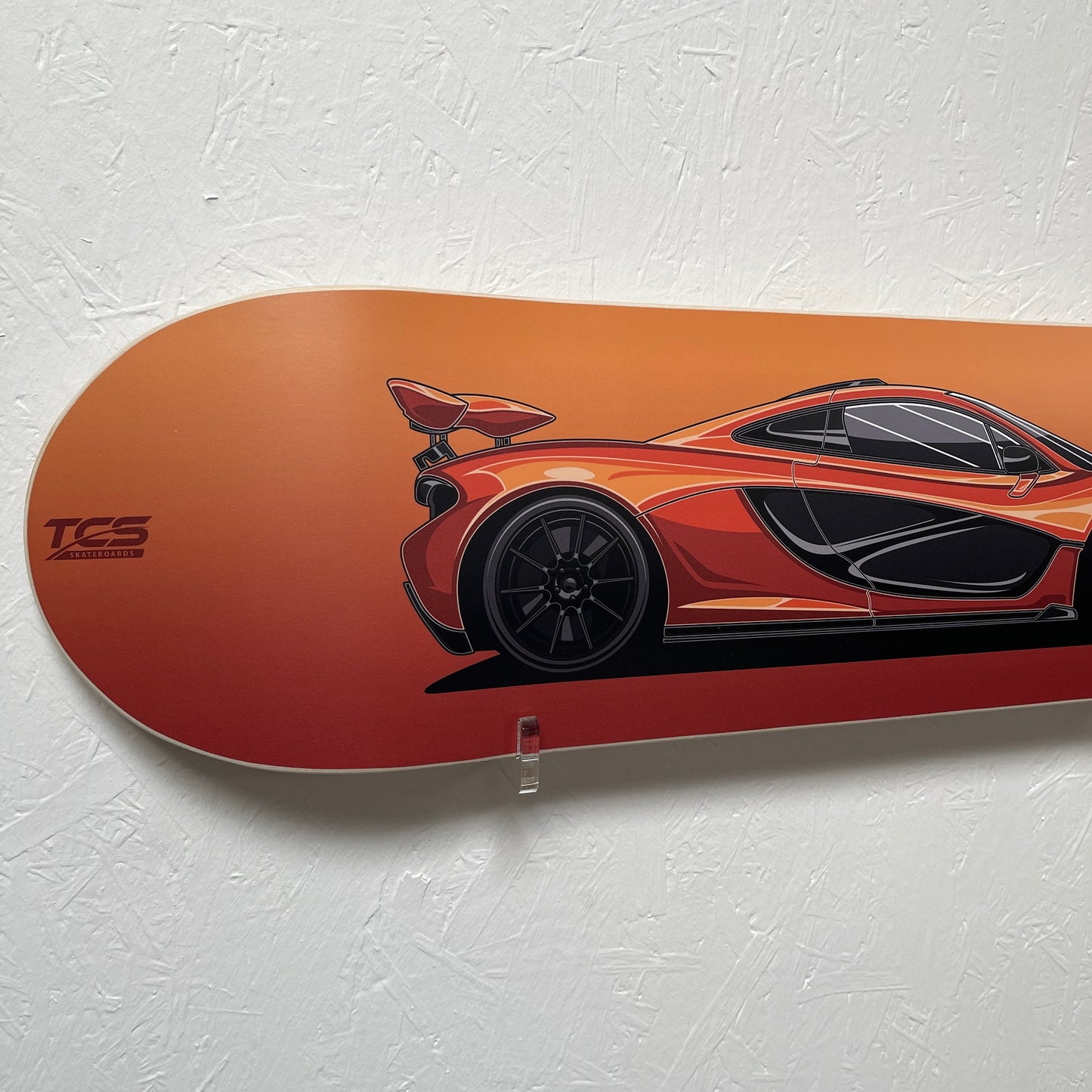 Skateboard deck with car design on a white background