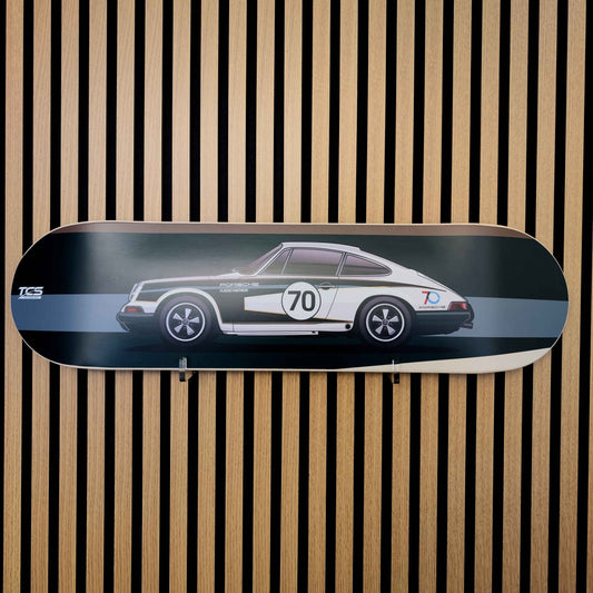 Skateboard deck with a car design on a wooden slat background