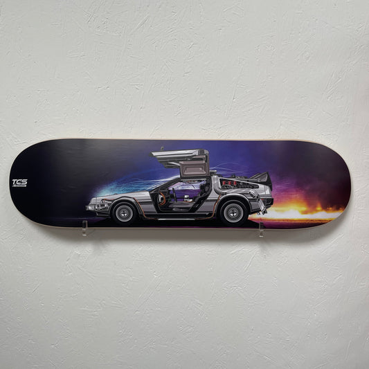 Skateboard deck with a car design on a white wall