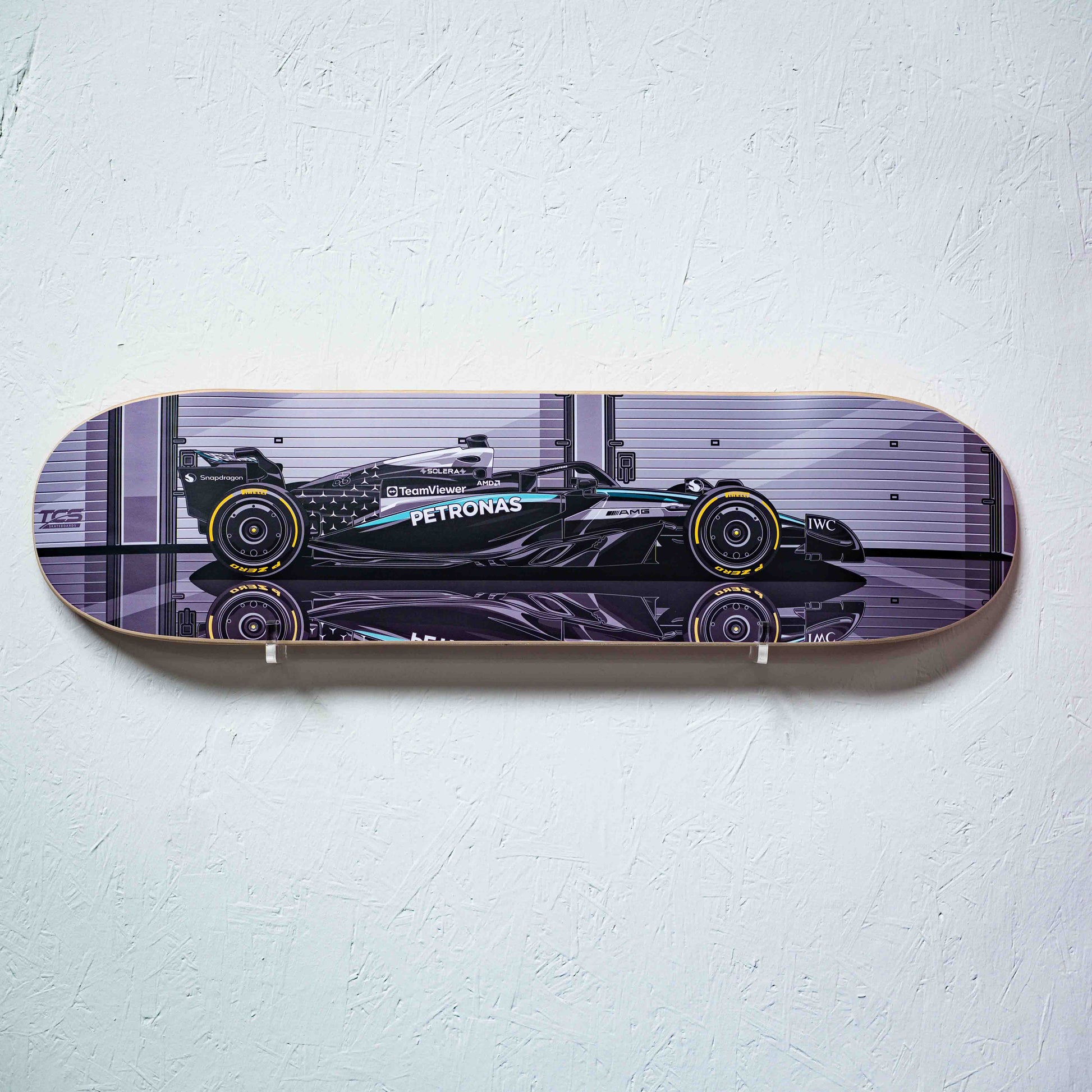 Skateboard with Formula 1 car design on a white wall