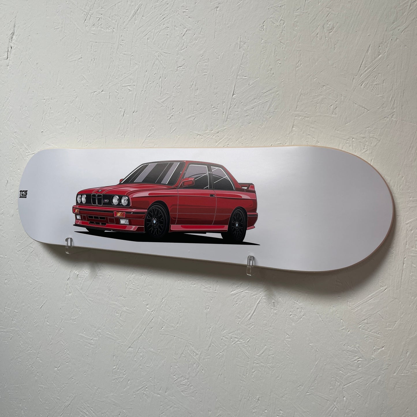 Skateboard deck with a red car design on a white background