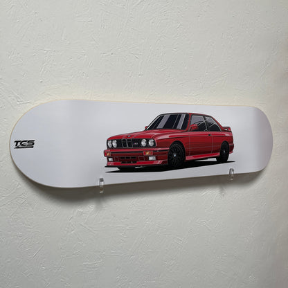 Skateboard deck with a red car design on a white background