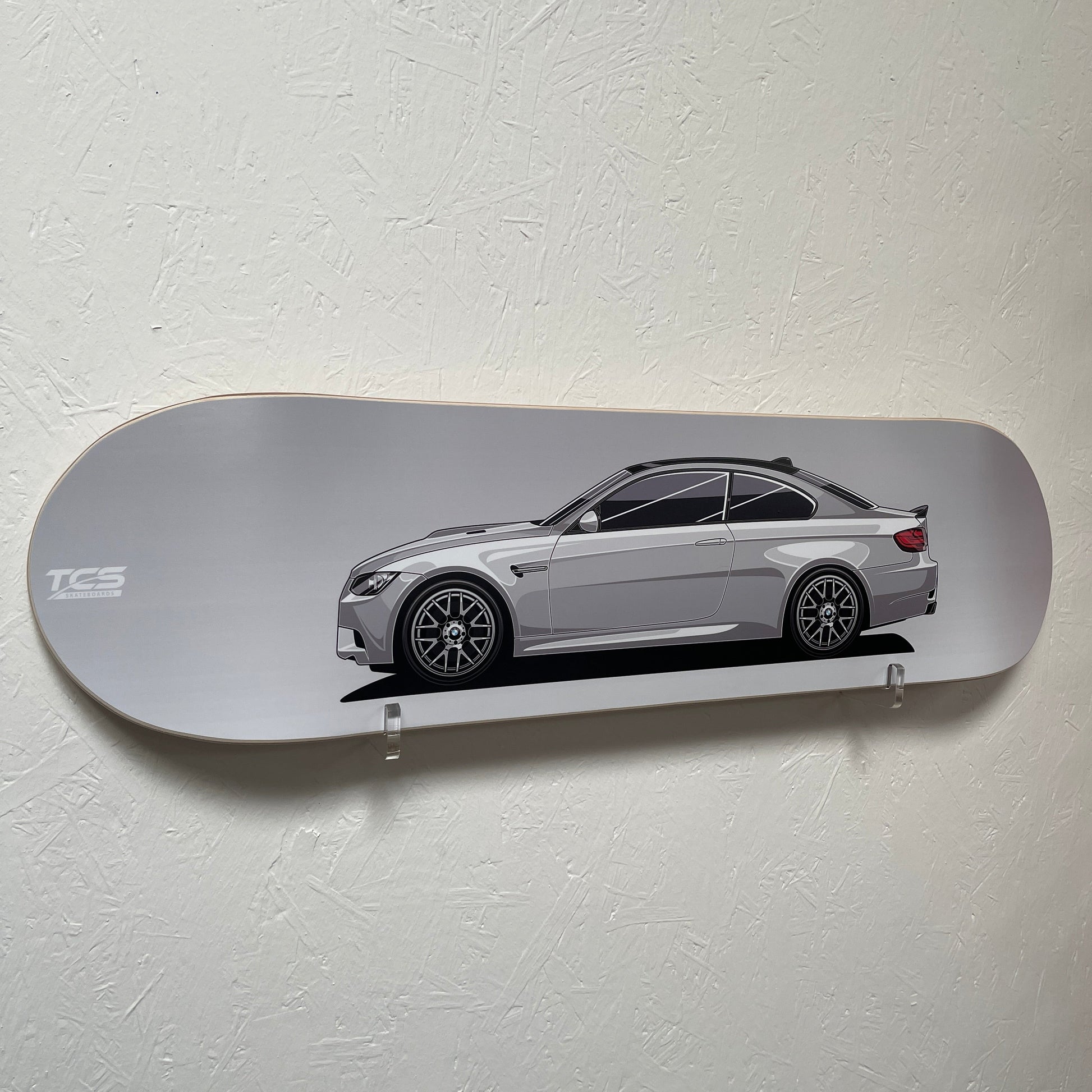 Skateboard with BMW E92 M3 car design on a white wall