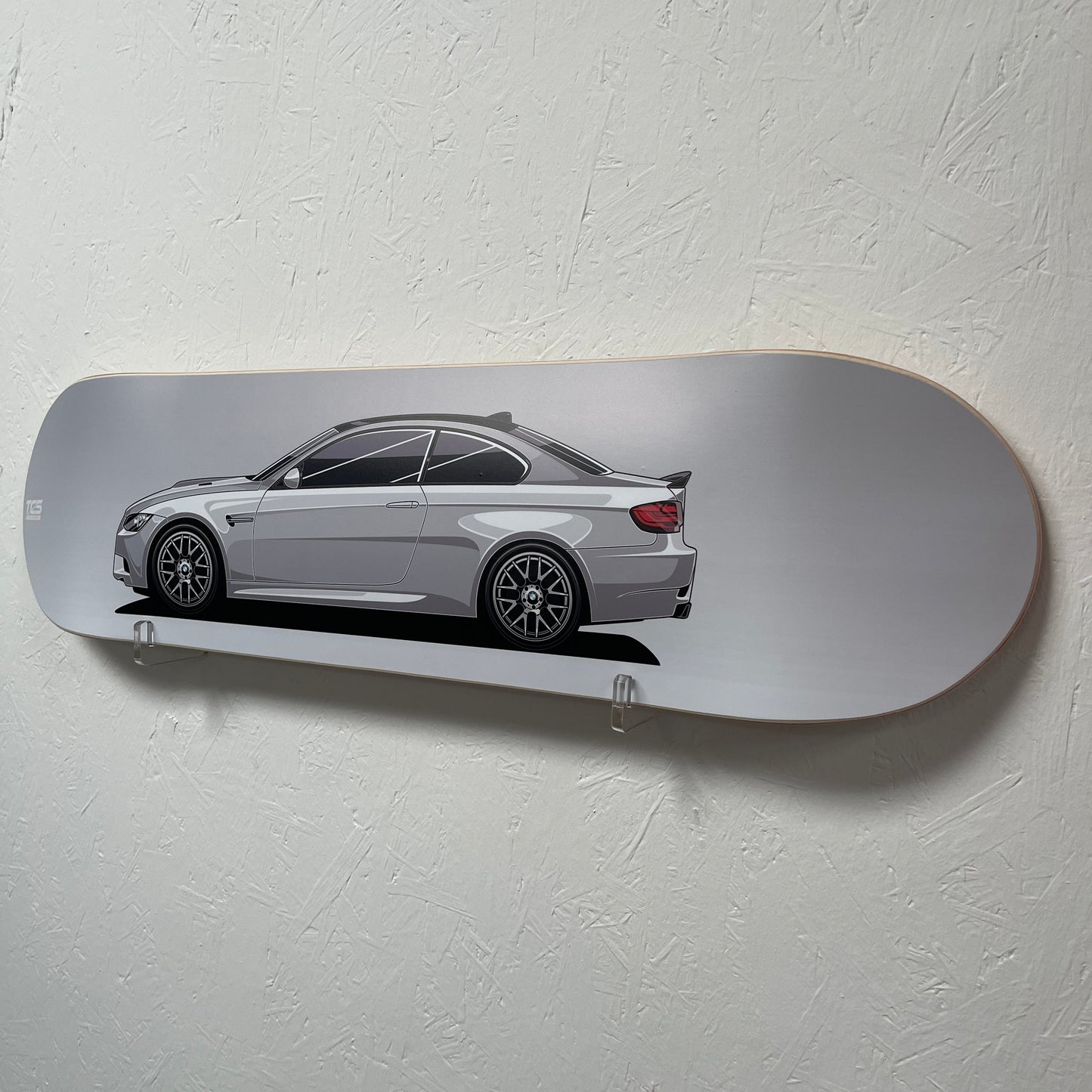 Skateboard with a car design on a white wall
