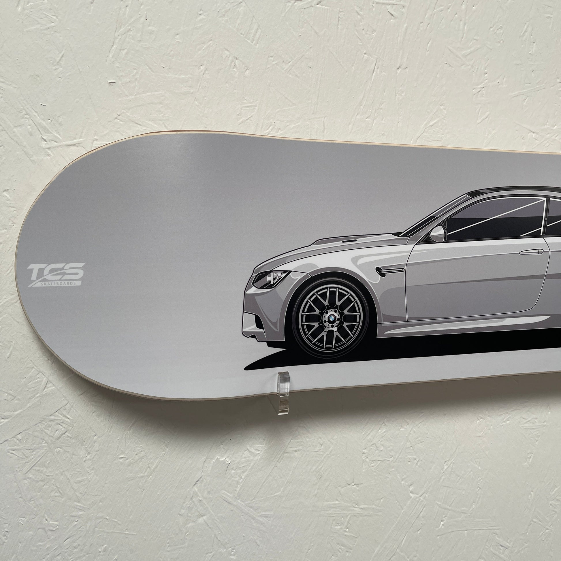 Skateboard with car design on a light gray background