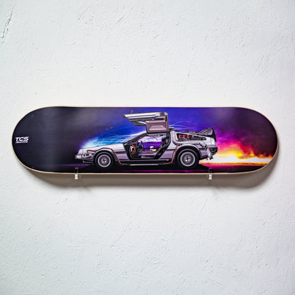 Skateboard deck with a futuristic car design on a white wall