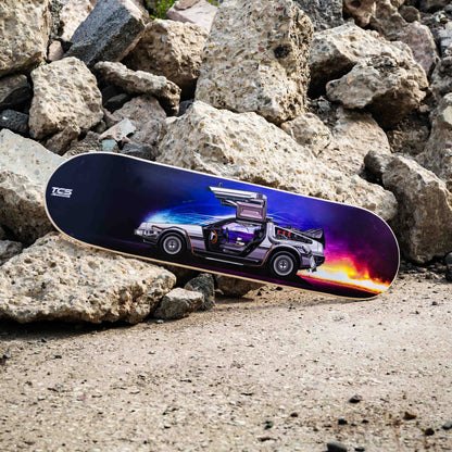Skateboard with a car design on a rocky surface