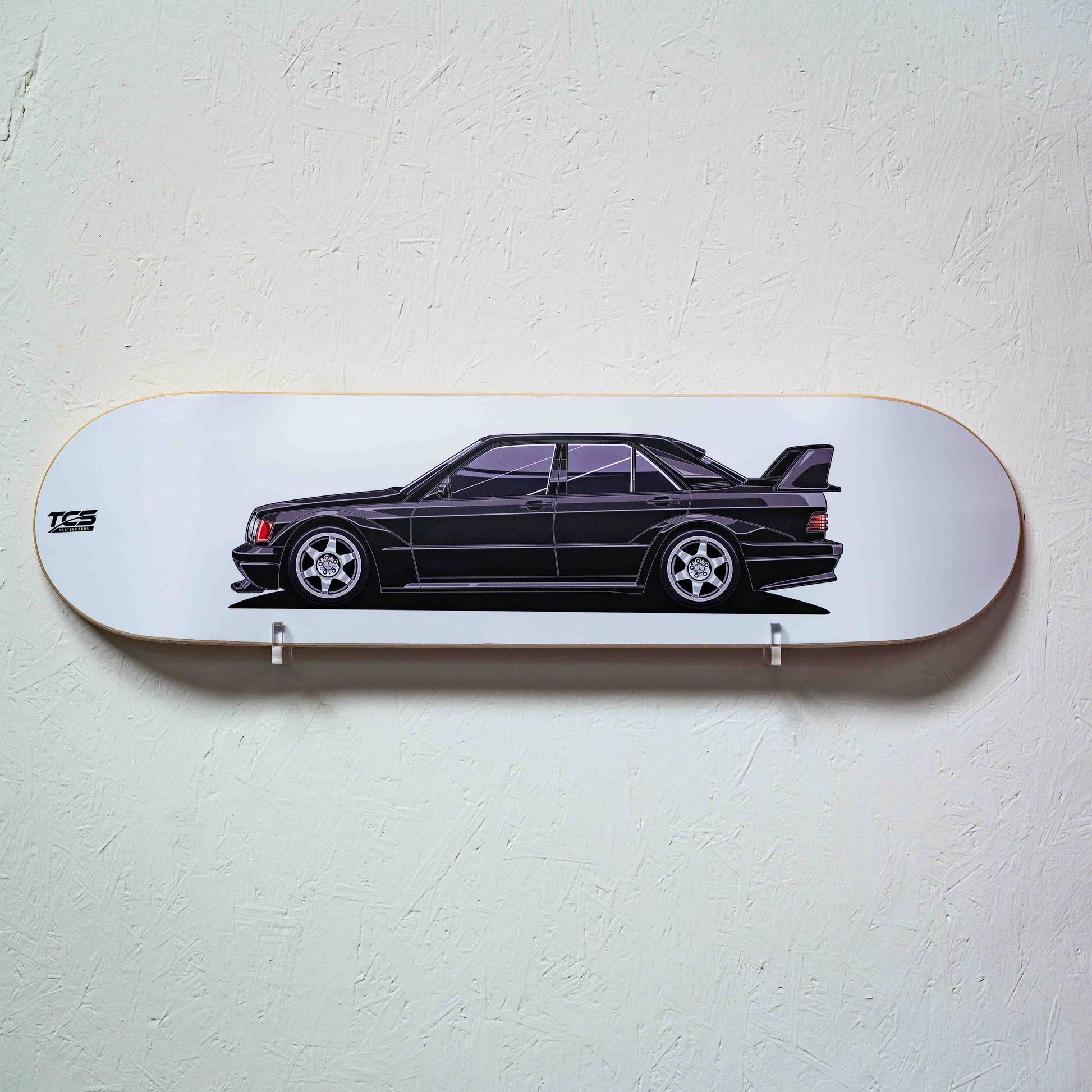 Skateboard deck with a black car design on a white background
