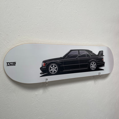 Skateboard deck with a black car illustration and TCS logo on a white background