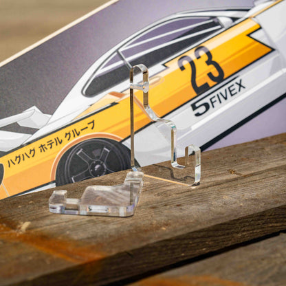 Clear acrylic stand with a model car on a wooden surface