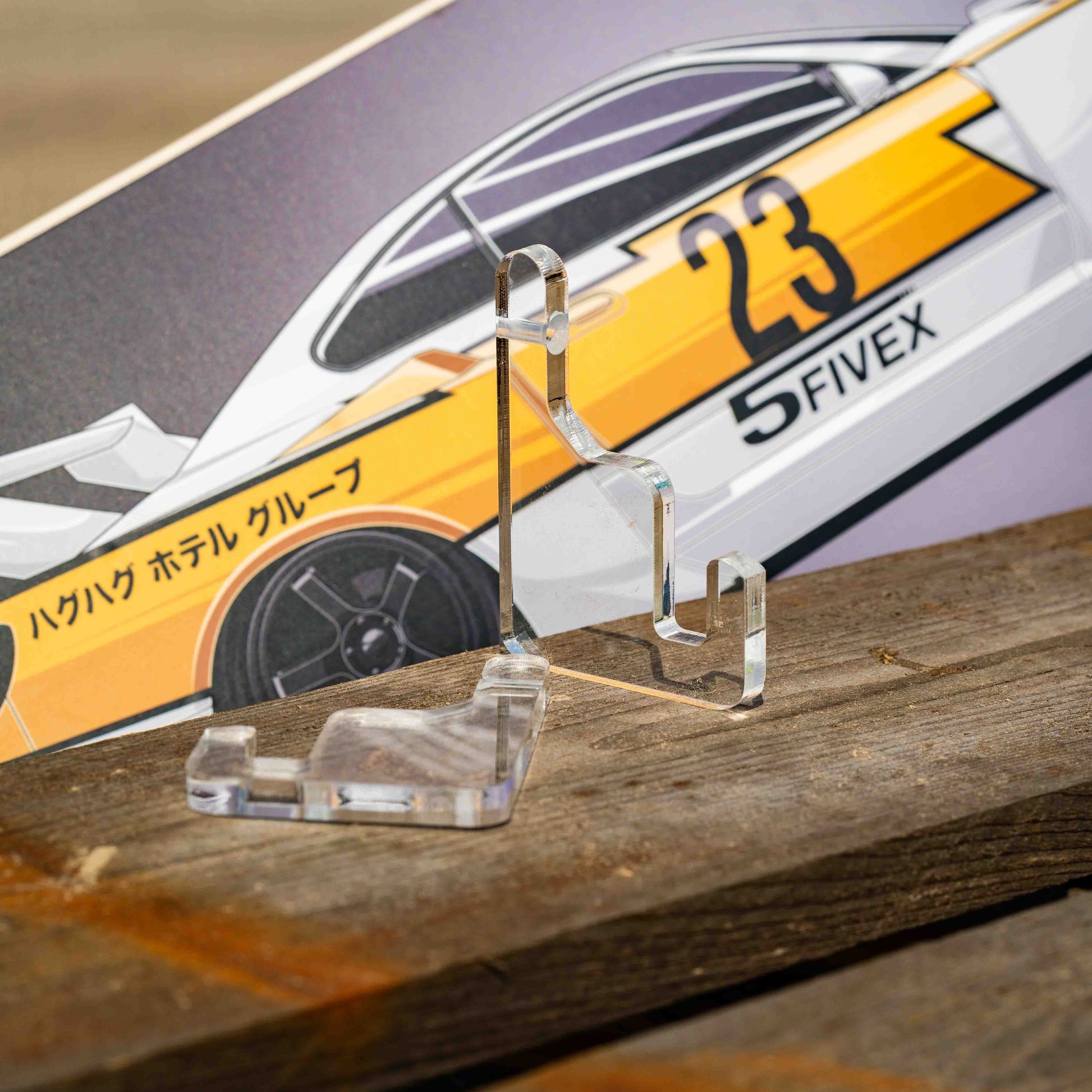 Clear acrylic stand with a skateboard deck in the background
