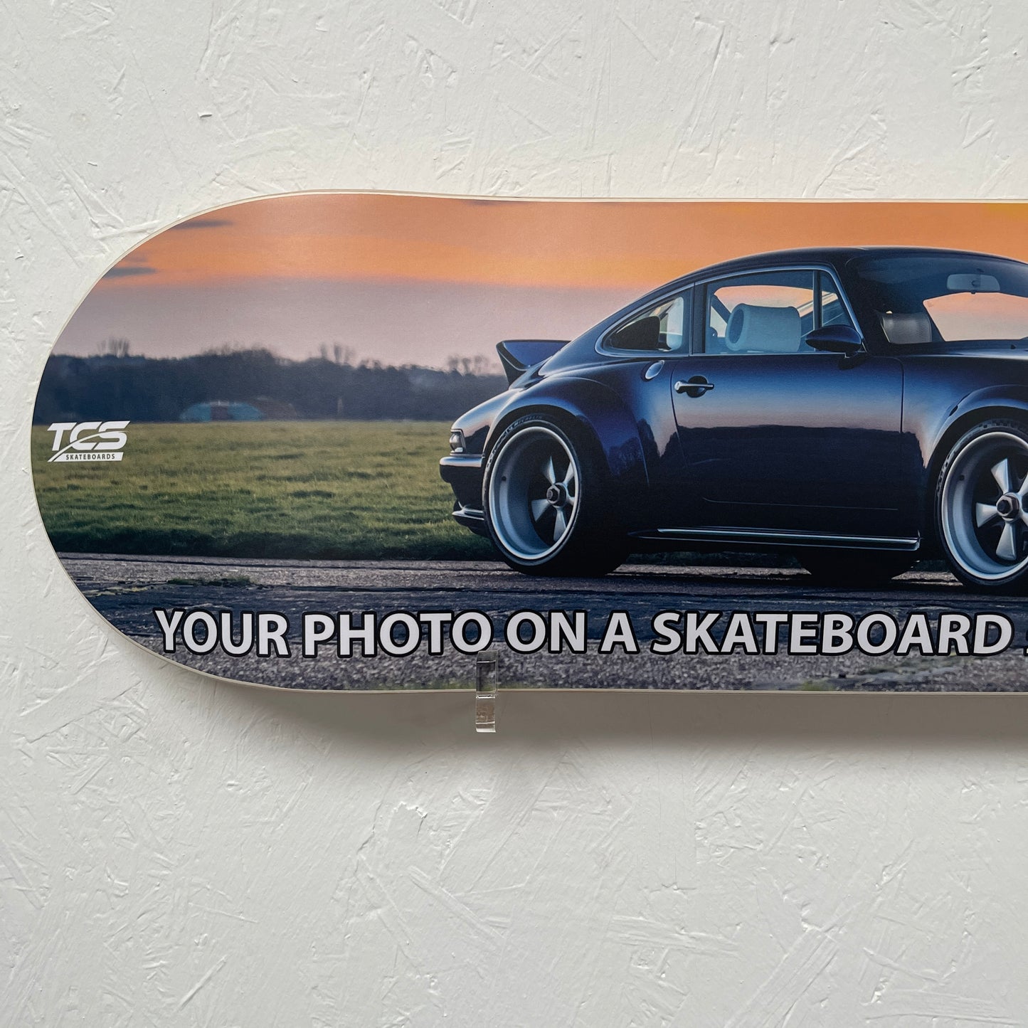 Skateboard with a car photo on a textured white background