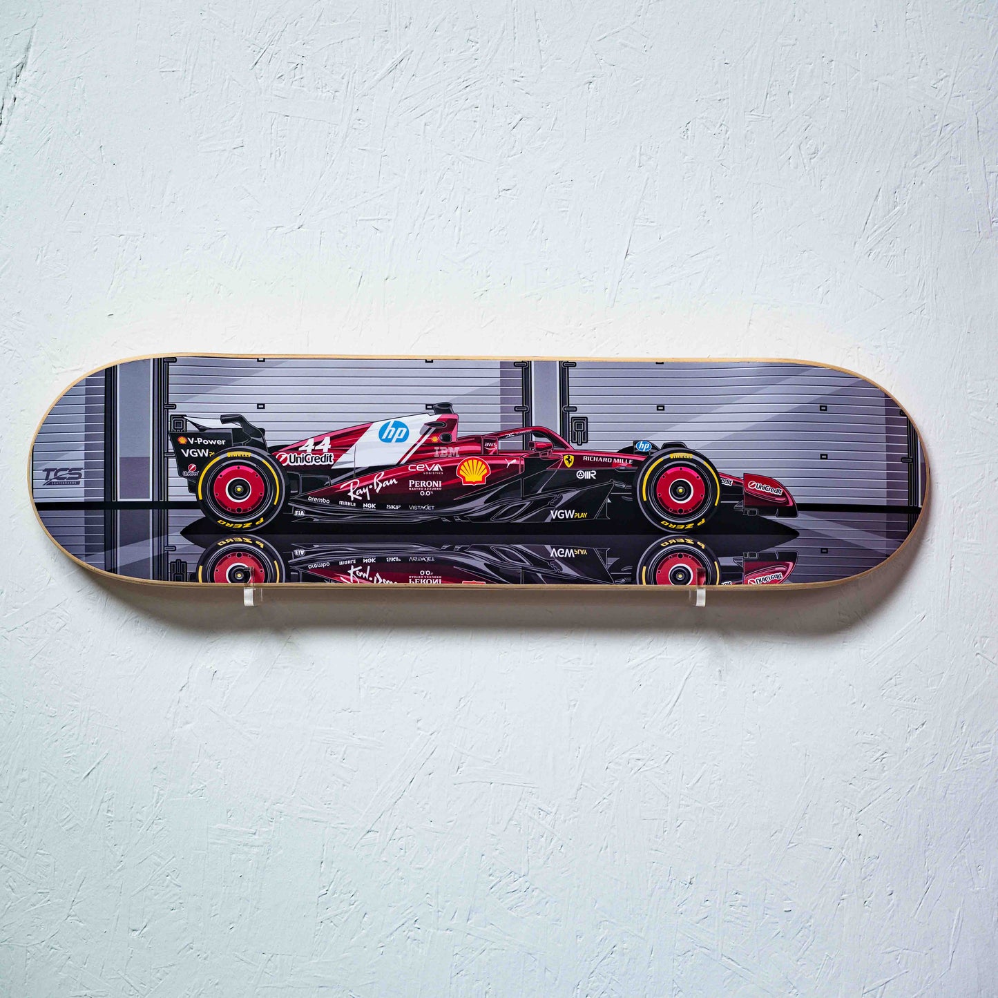Skateboard deck with Formula 1 car design on a white wall