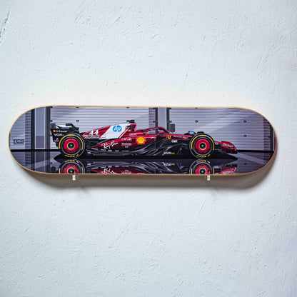 Skateboard deck with Formula 1 car design on a white wall