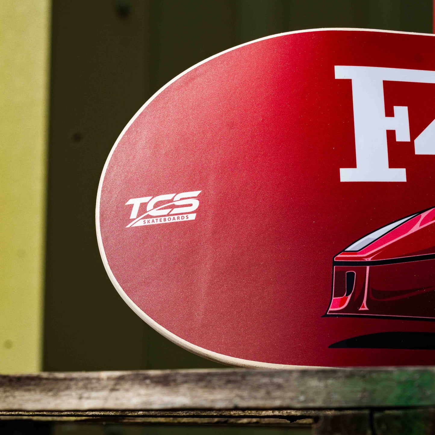 Red deck with 'F4' and 'TCS' branding on a wooden surface
