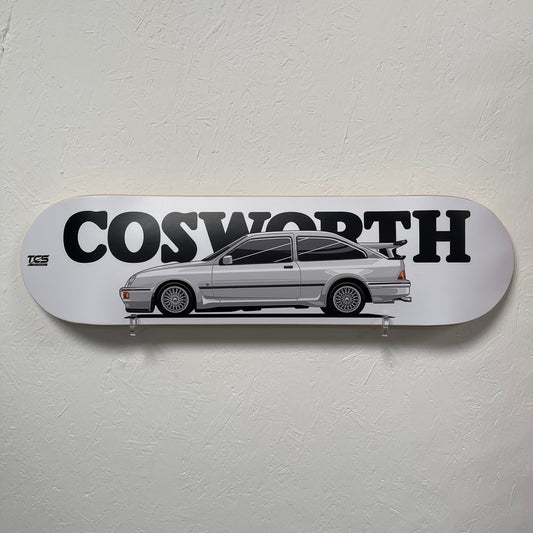 Skateboard deck with a car design and 'Cosworth' branding on a white background