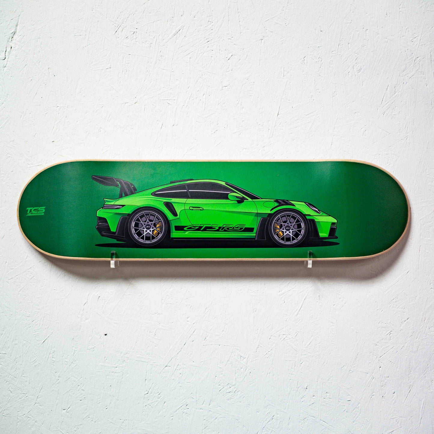 Skateboard deck with a green sports car design on a white background