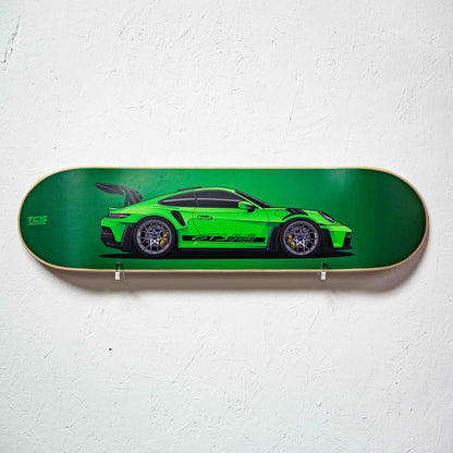 Skateboard deck with a green sports car design on a white background