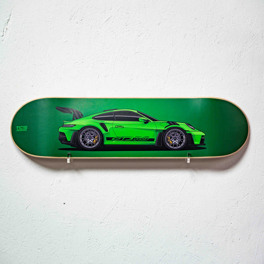 Skateboard deck with a green sports car design on a white background