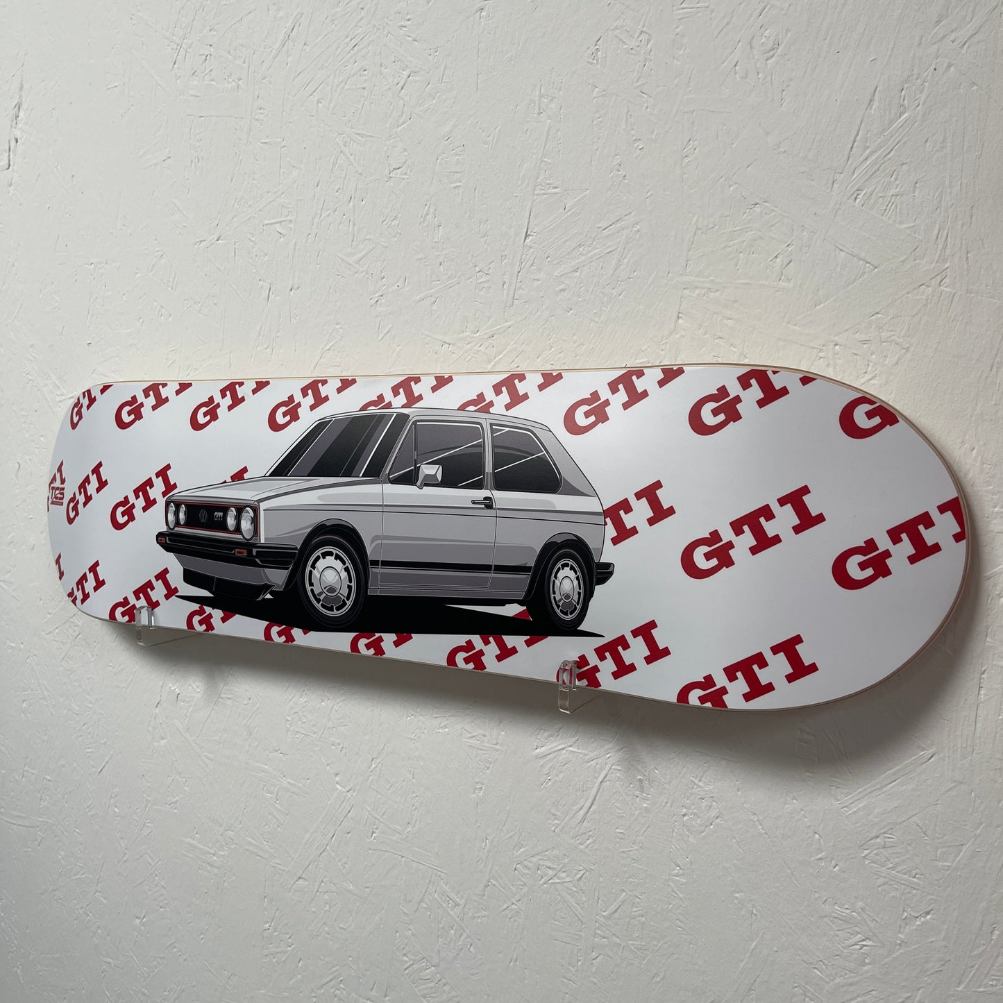 Skateboard deck with car design and red text on a white background