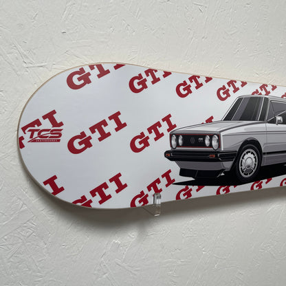 White skateboard with red branding on a gray background