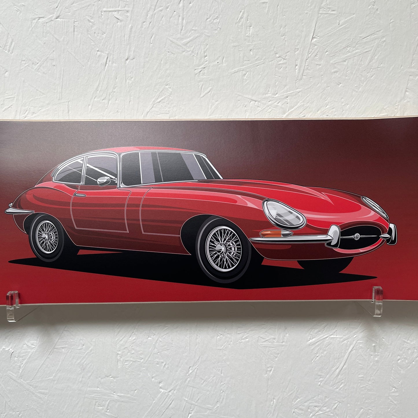 Red vintage car design on a textured white wall