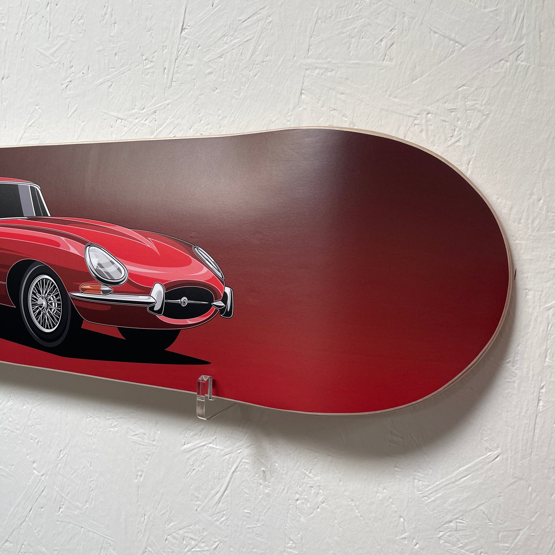 Red snowboard with a car design on a white background