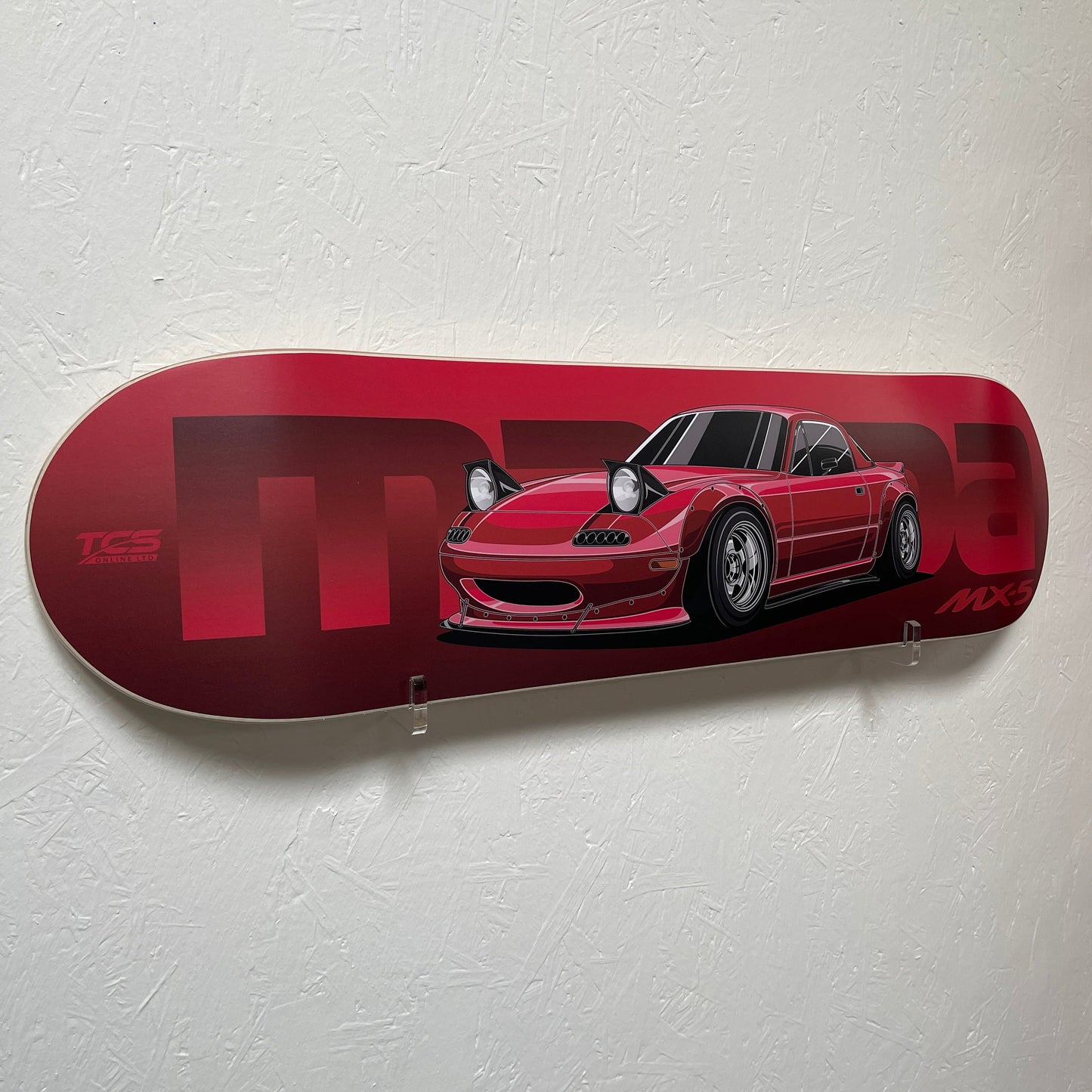 Red skateboard deck with a car design on a white background