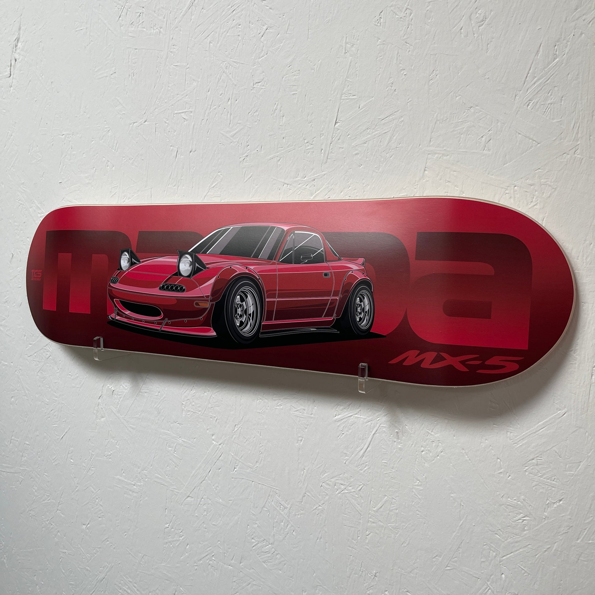 Red skateboard deck with a car design and 'MX5' text on a white background