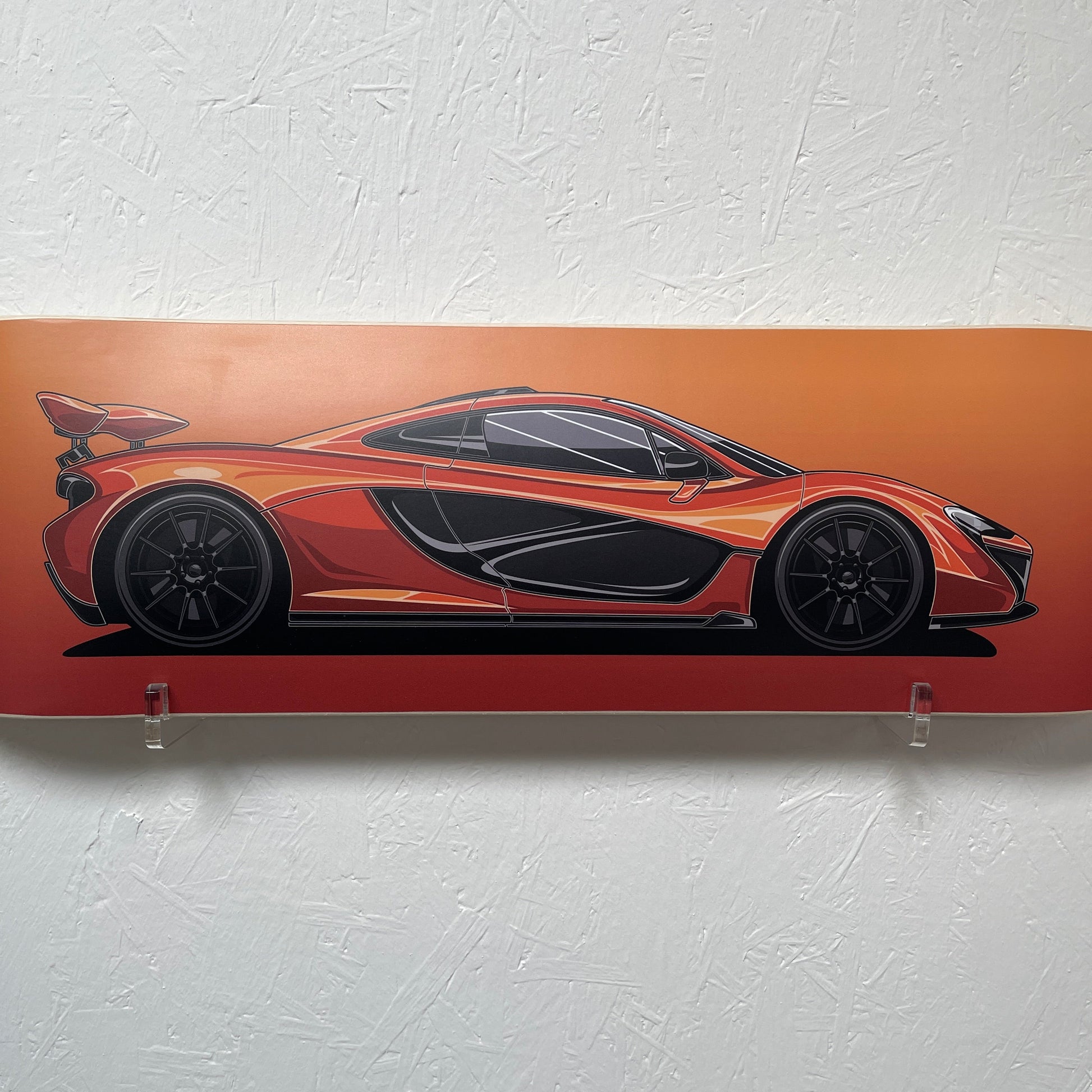 Decorative wall art of a stylized car on an orange background