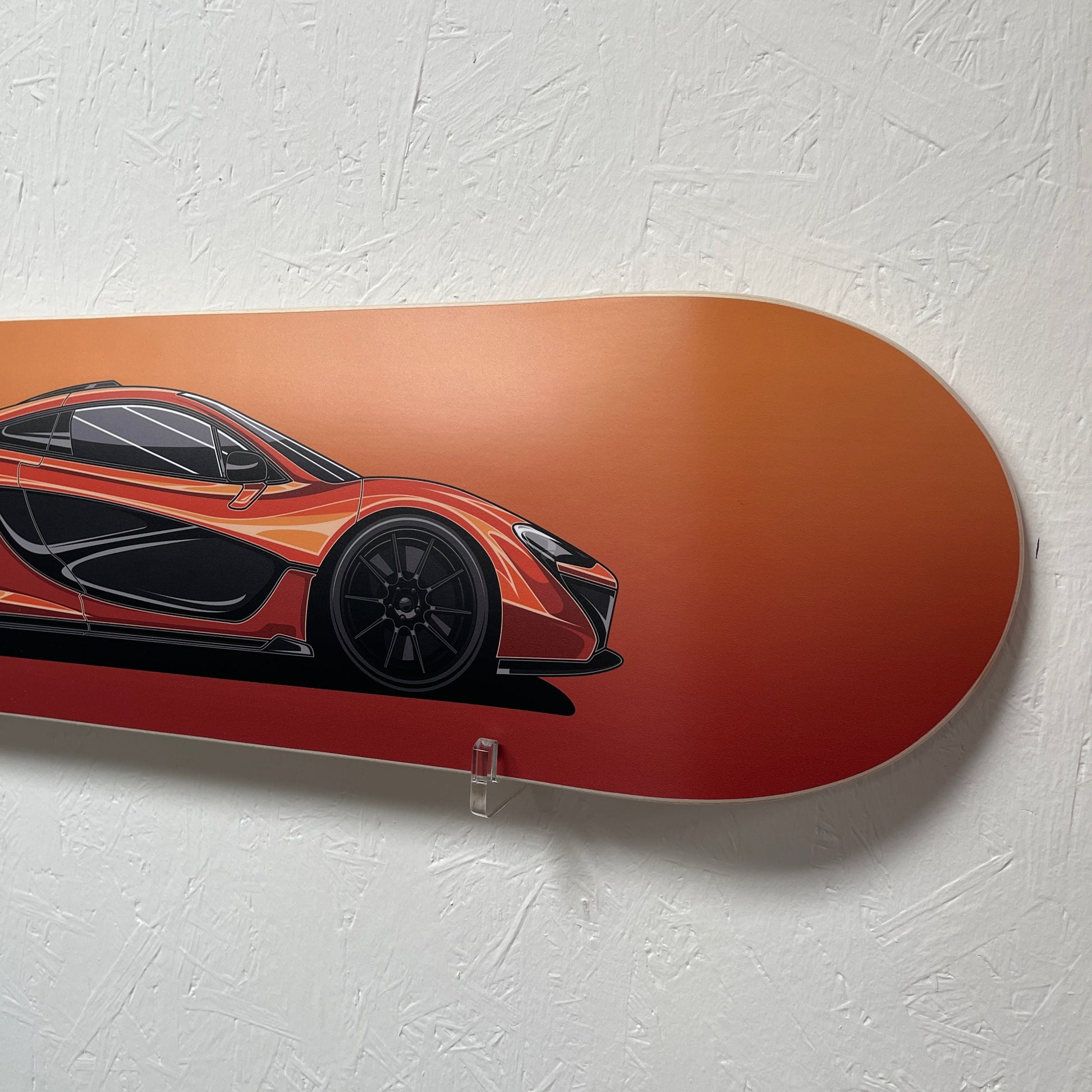 Skateboard deck with a car design on a light gray background