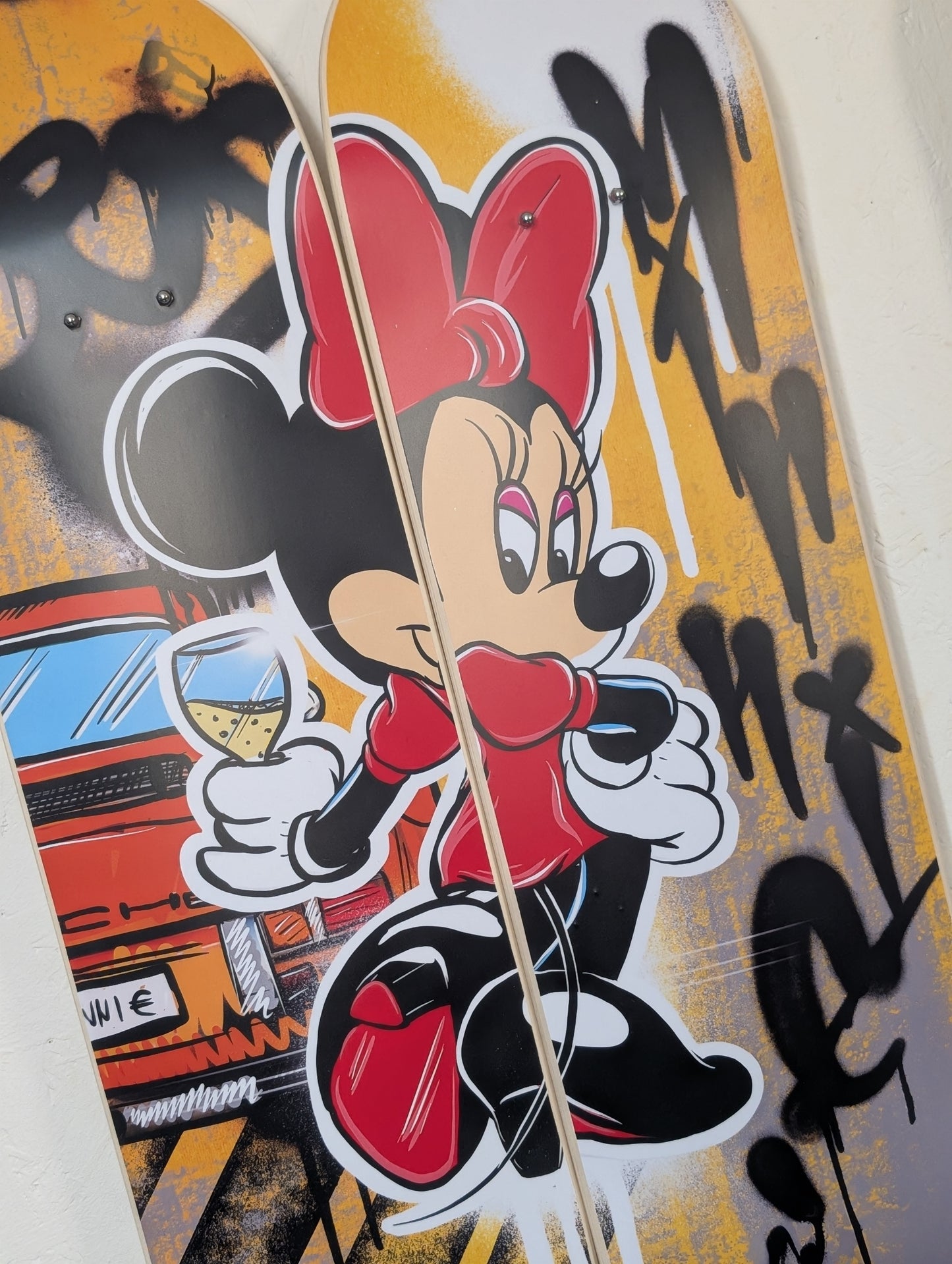 Skateboard deck with Minnie Mouse design and colorful graphics