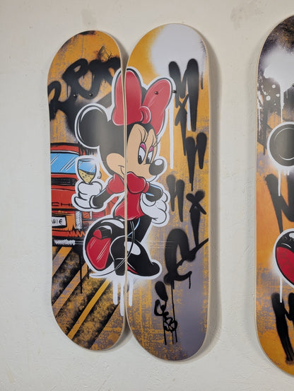 Two skateboard decks with a stylized character design on a white background