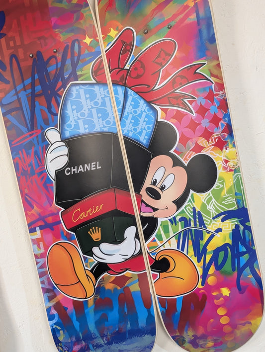 Colorful skateboard with cartoon character and brand logos on a white background