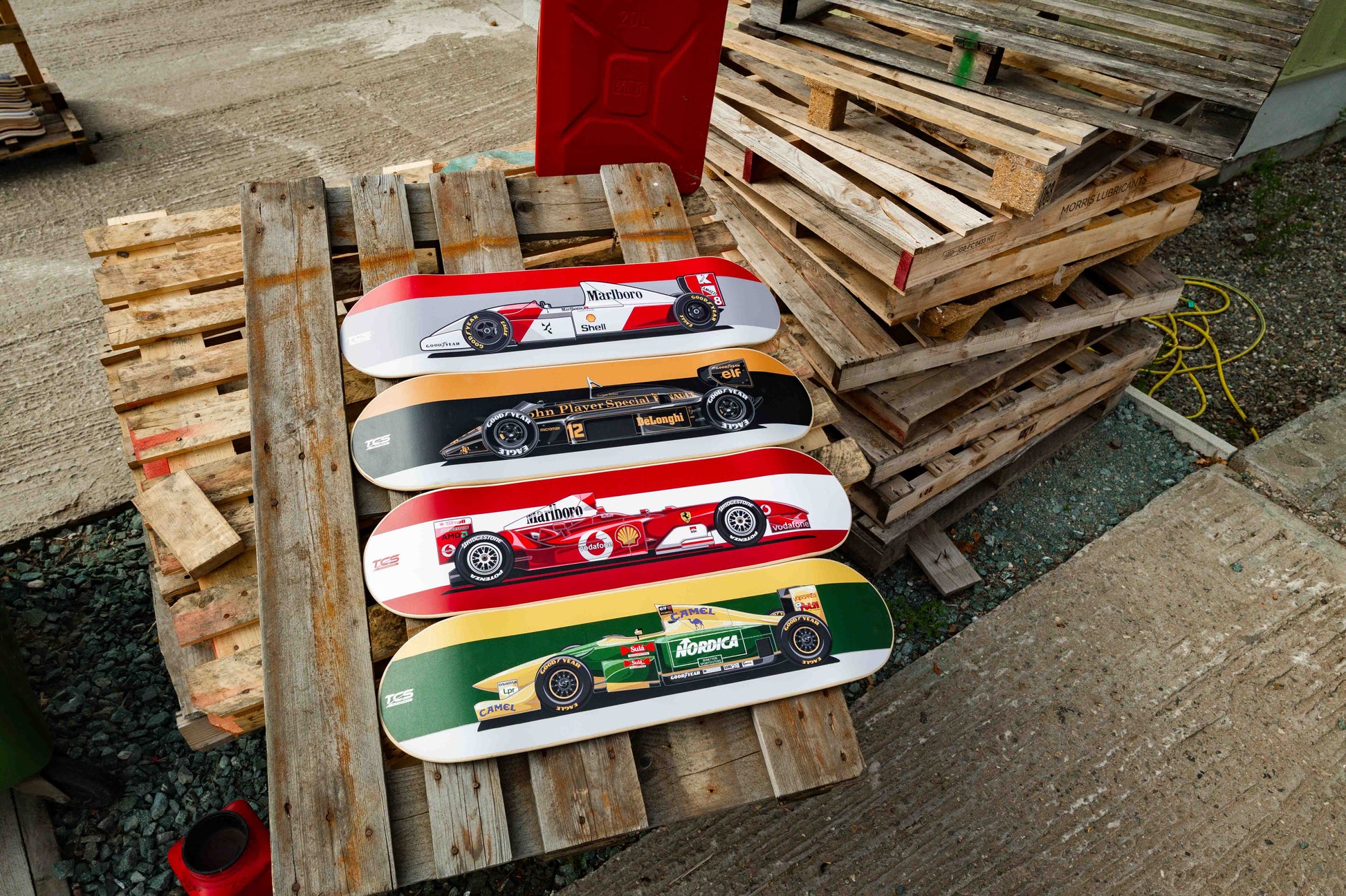 Skateboards with car designs on a wooden pallet