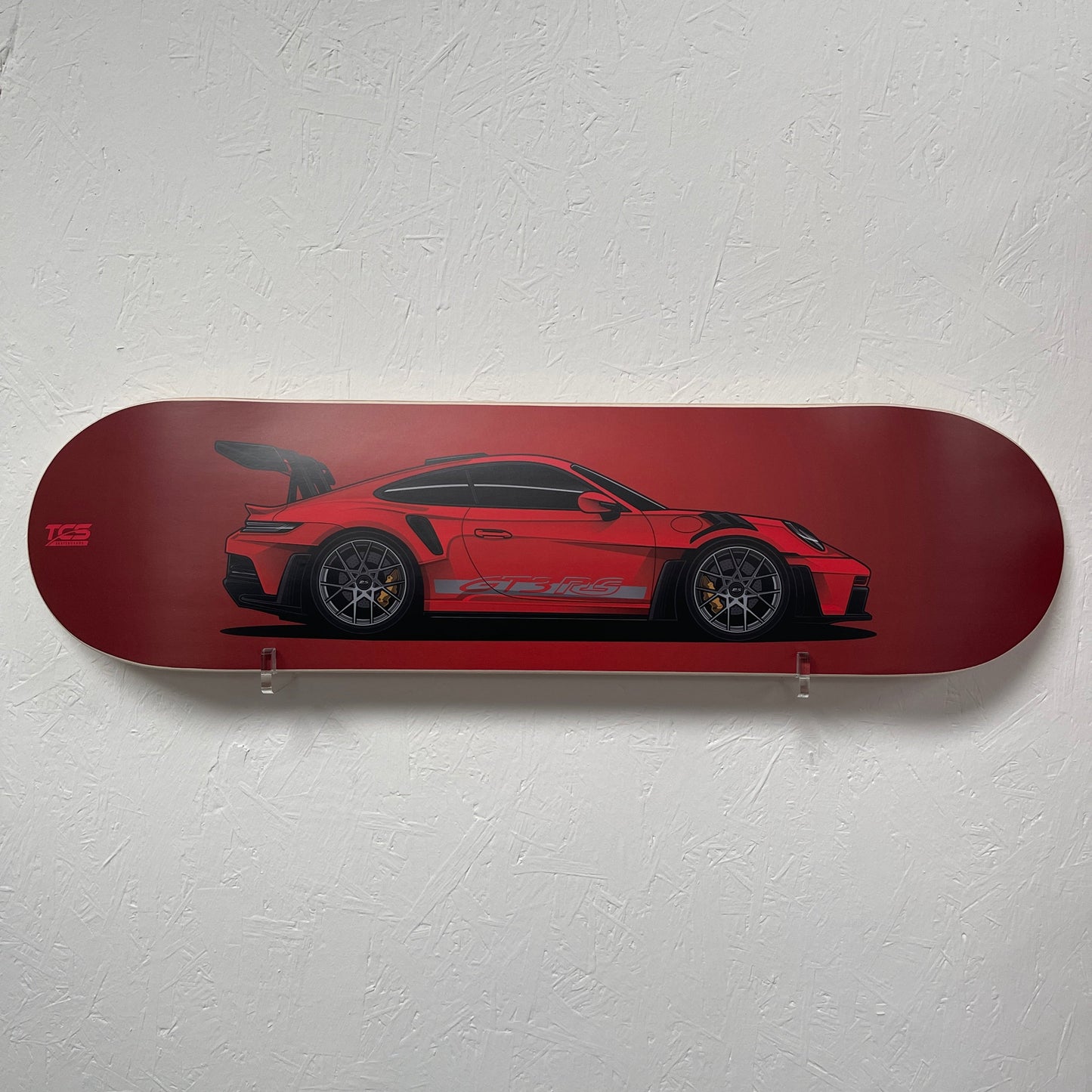 Red GT3RS skateboard deck with a red car design on a white wall