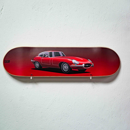 Skateboard deck with a red car design on a light gray background