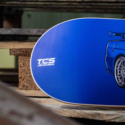 Blue skateboard deck with a logo on a wooden surface