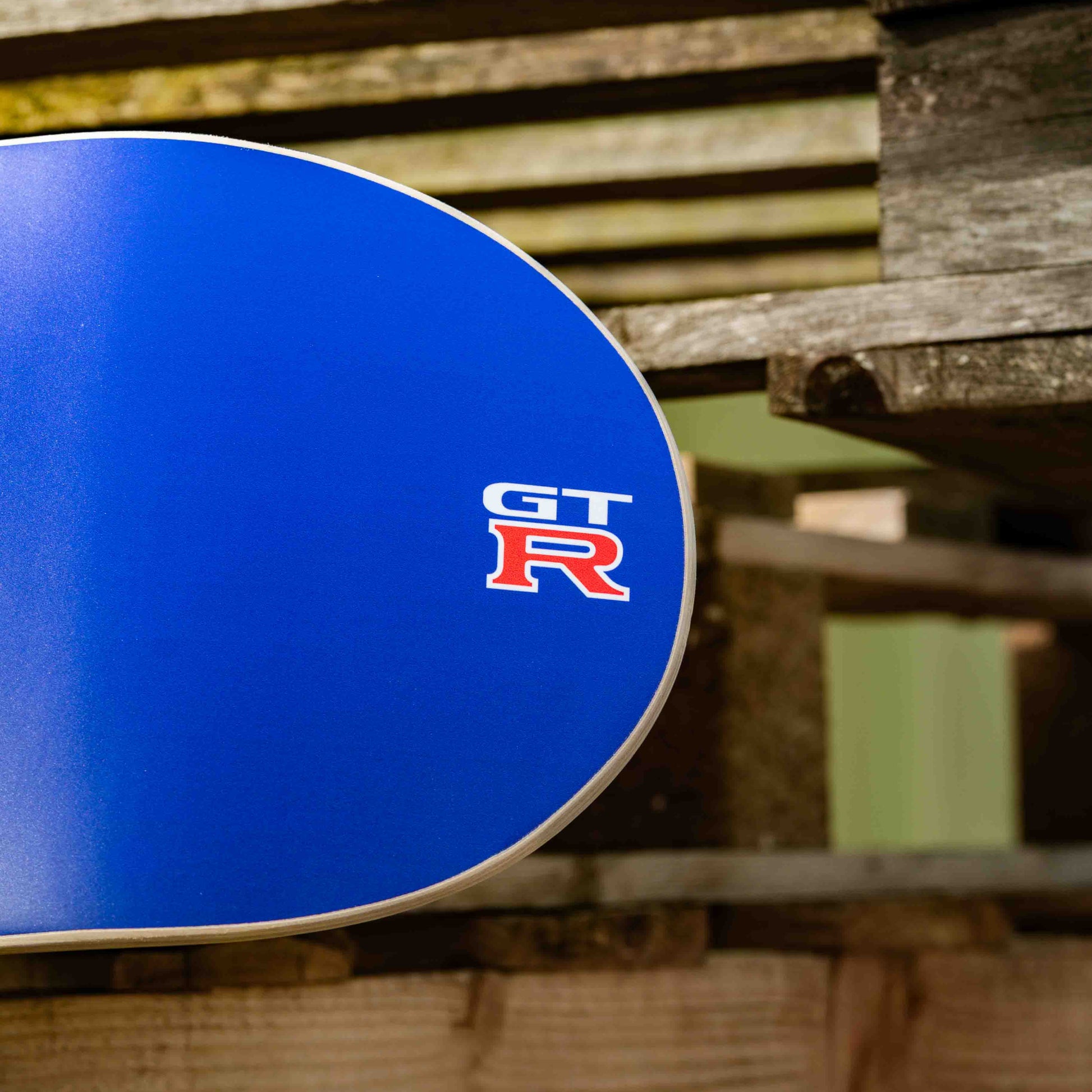 Blue car rim with GT R logo on a wooden pallet