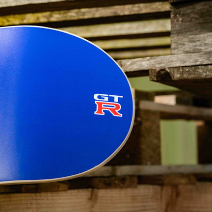 Blue car rim with GT R logo on a wooden pallet