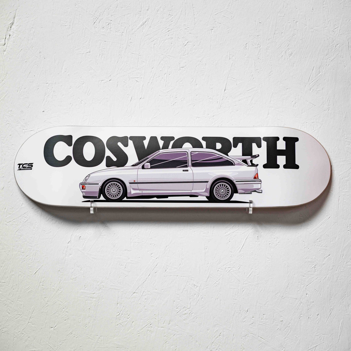 Skateboard with a car illustration and 'Cosworth' branding on a white background