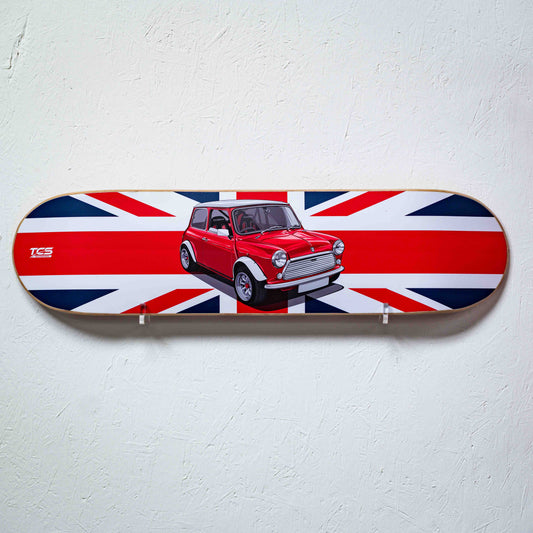 Skateboard deck with a red car and British flag design on a white wall.