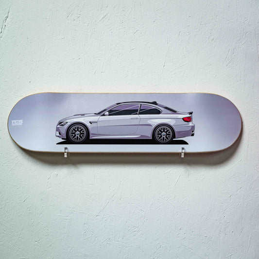 Skateboard deck with a car design on a light gray background