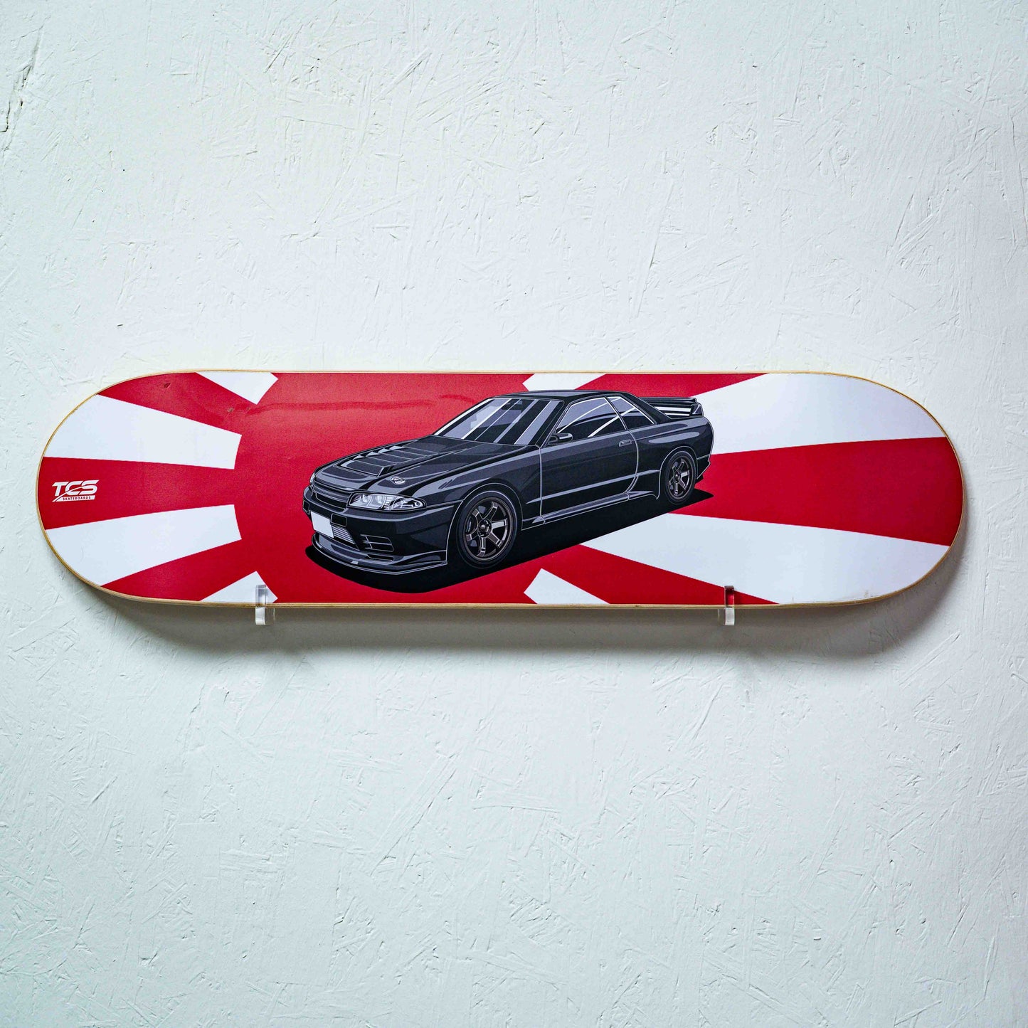 Skateboard deck with a car illustration on a red and white striped background