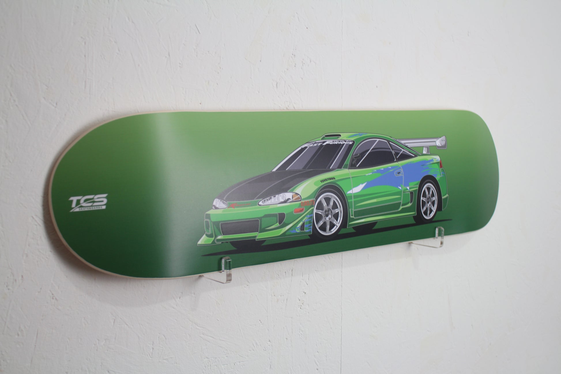 Skateboard deck with a green car design