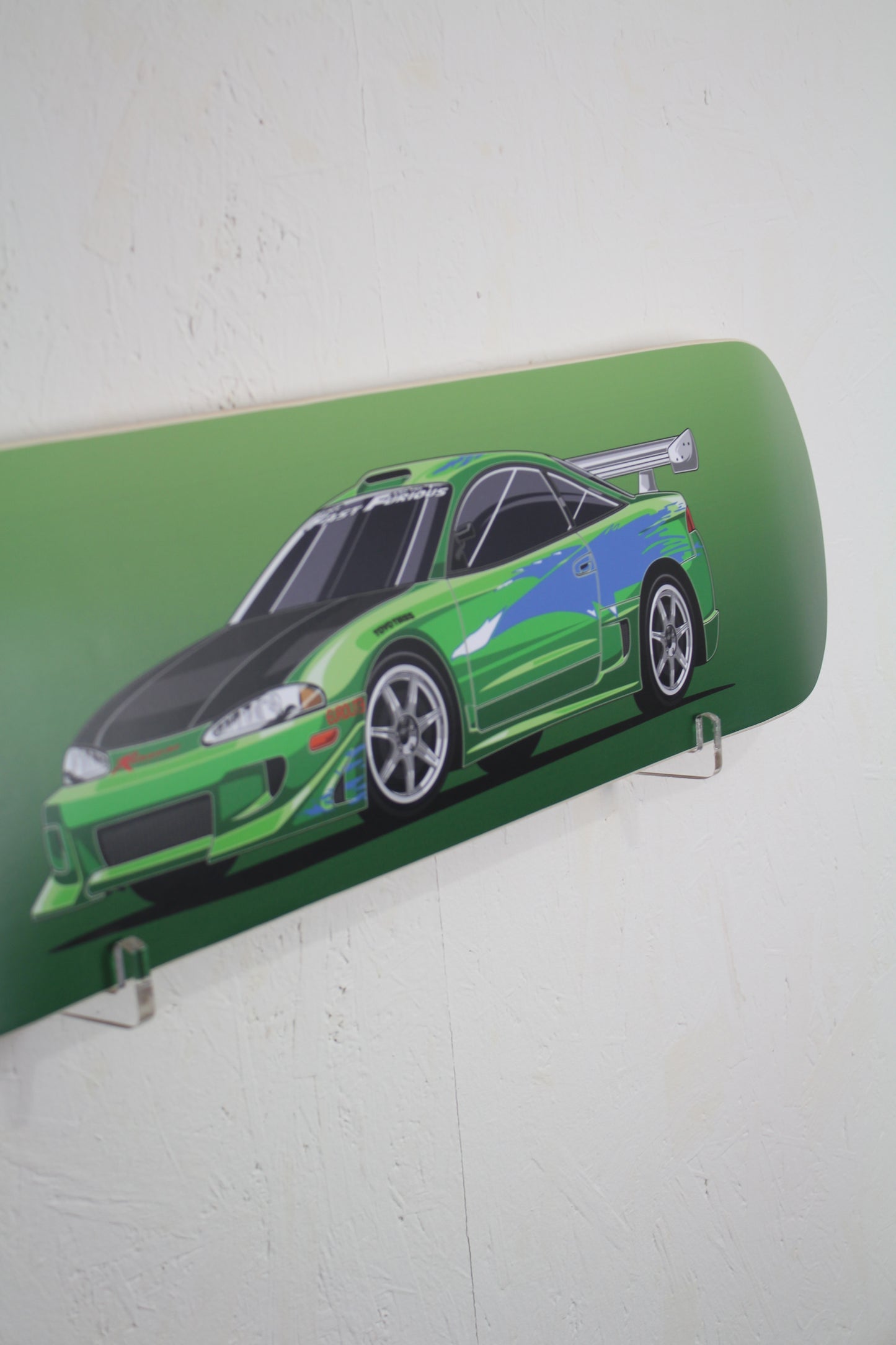 Skateboard deck with a green car design