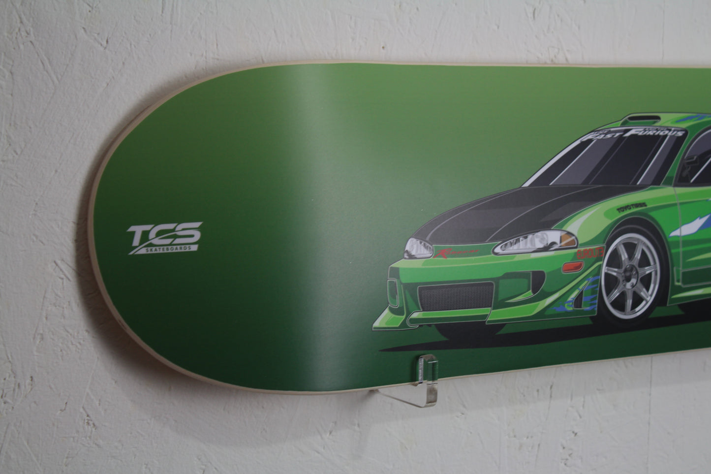 Skateboard deck with a green car design